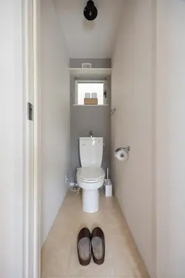 a bathroom with a toilet and two slippers on the floor at Entire Home in Sangenjaya, 2-stops to Shibuya, and Shinjuku, Lani's Place at Sangenjaya in Tokyo