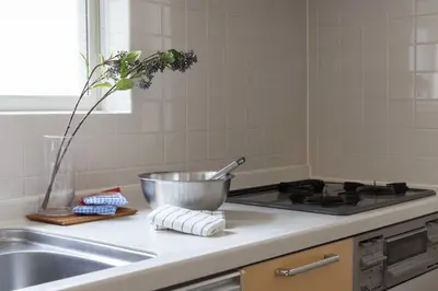 a kitchen counter with a sink and a bowl on a stove at Entire Home in Sangenjaya, 2-stops to Shibuya, and Shinjuku, Lani's Place at Sangenjaya in Tokyo
