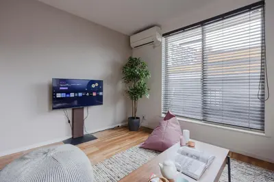 a living room with a large window and a tv at Entire Home in Sangenjaya, 2-stops to Shibuya, and Shinjuku, Lani's Place at Sangenjaya in Tokyo