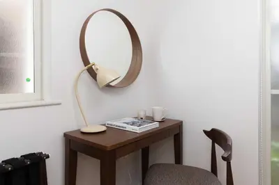 a table with a lamp and a mirror on it at Entire Home in Sangenjaya, 2-stops to Shibuya, and Shinjuku, Lani's Place at Sangenjaya in Tokyo
