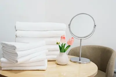 a pile of towels on a table with a mirror at 3 minutes to Shinjuku by subway-Nakanokaikan I in Tokyo