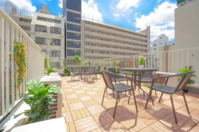 a patio with tables and chairs on a balcony at 3 minutes to Shinjuku by subway-Nakanokaikan I in Tokyo