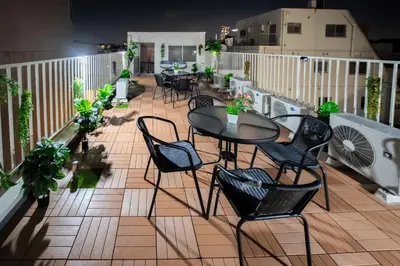 a patio with tables and chairs on a balcony at 3 minutes to Shinjuku by subway-Nakanokaikan I in Tokyo