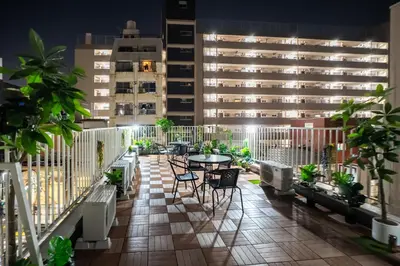 a balcony with a table and chairs and a building at 3 minutes to Shinjuku by subway-Nakanokaikan I in Tokyo
