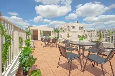 a patio with tables and chairs on a balcony at 3 minutes to Shinjuku by subway-Nakanokaikan I in Tokyo