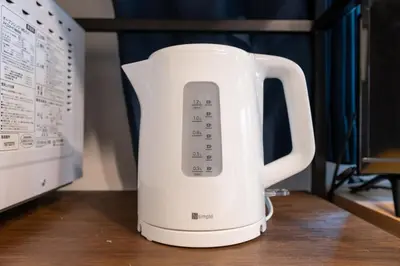 a white kettle sitting on a table next to a microwave at Open Sale Asakusa Skytree Hotel like space 3 minutes from the station in Tokyo
