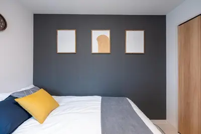 a bedroom with four pictures on the wall and a bed at Open Sale Asakusa Skytree Hotel like space 3 minutes from the station in Tokyo