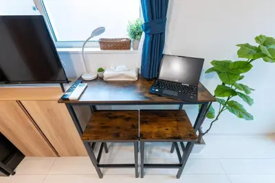 a desk with a laptop computer on top of it at Open Sale Asakusa Skytree Hotel like space 3 minutes from the station in Tokyo