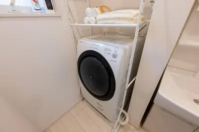a washer and dryer in a small bathroom at Open Sale Asakusa Skytree Hotel like space 3 minutes from the station in Tokyo