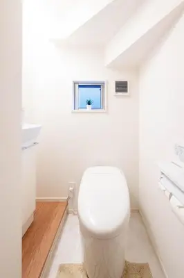 a white bathroom with a toilet and a window at \u5343\u5c0b 130t in Tokyo
