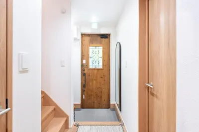 a hallway with a wooden door in a house at \u5343\u5c0b 130t in Tokyo