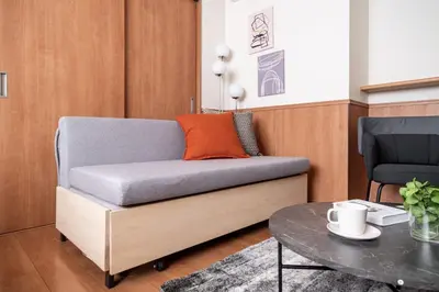 a couch in a living room with a table at \u30e2\u30f3 \u30b7\u30e3\u30c8\u30fc\u4e2d\u91ce\u54f2\u5b66\u5802 in Tokyo