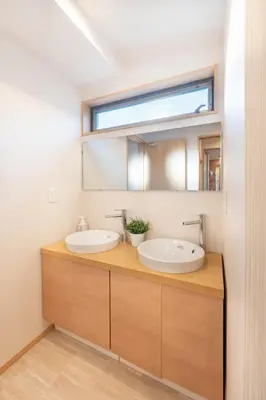 a bathroom with two sinks and a mirror at \u745e\u6c90 128t in Tokyo
