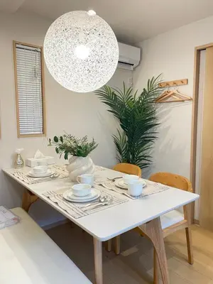 a white dining room table with chairs and a chandelier at \u745e\u6c90 128t in Tokyo