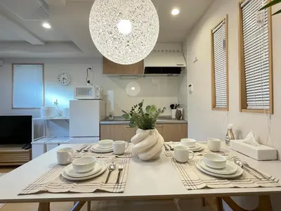 a kitchen with a table with plates and dishes on it at \u745e\u6c90 128t in Tokyo