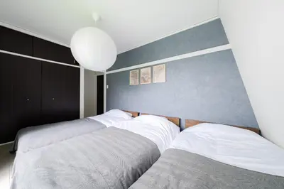 two beds sitting next to each other in a bedroom at Maison Nagasaki Five 3F MN3 in Tokyo