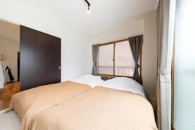 a bedroom with a large bed with a window at Maison Nagasaki Five 3F MN3 in Tokyo