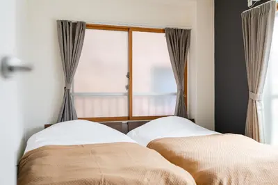 a bedroom with a bed and a window at Maison Nagasaki Five 3F MN3 in Tokyo