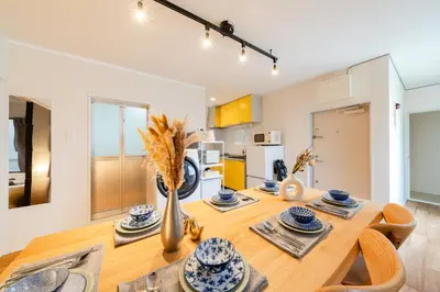 a kitchen and dining room with a wooden table at Maison Nagasaki Five 3F MN3 in Tokyo