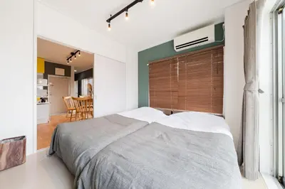 a bedroom with a large bed with a wooden headboard at Maison Nagasaki Five 4F MN4 in Tokyo