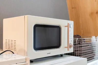 a microwave oven sitting on top of a shelf at Maison Nagasaki Five 4F MN4 in Tokyo