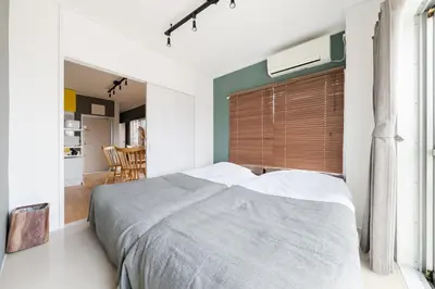 a bedroom with a large bed with a large window at Maison Nagasaki Five 4F MN4 in Tokyo