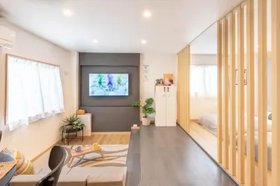 a living room with a tv on a wall at \u5922\u306e\u5bbf \u685c\u96c51F 131Ta in Tokyo