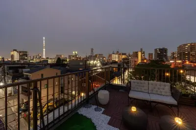 a balcony with a couch and a city at night at \u5922\u306e\u5bbf \u685c\u96c52F-3F 131Tb in Tokyo