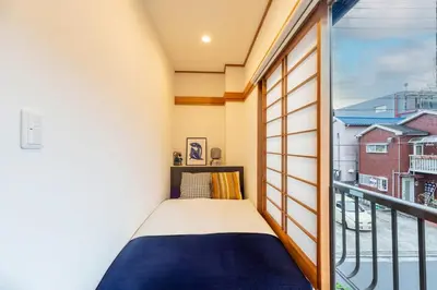 a small bedroom with a bed and a balcony at \u5922\u306e\u5bbf \u685c\u96c52F-3F 131Tb in Tokyo