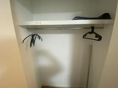 a room with a closet with a shelf above a toilet at be\u30c6\u30e9\u30b9204 in Tokyo