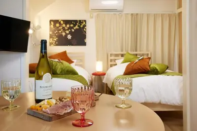 a room with a bottle of wine and glasses on a table at K&H立石5丁目m305 in Tokyo