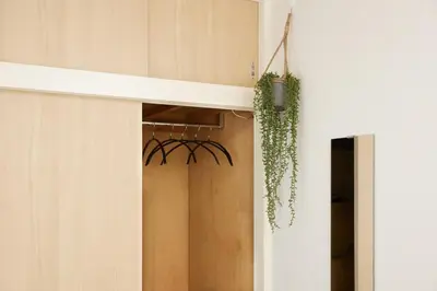 a spiderweb hanging from a door in a room at K&H立石5丁目m305 in Tokyo