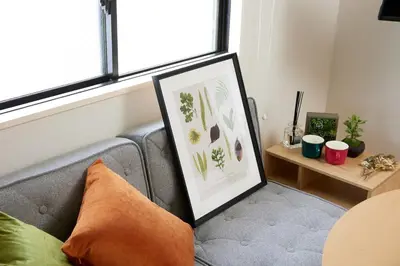 a couch with a picture on it in a living room at K&H立石5丁目m305 in Tokyo