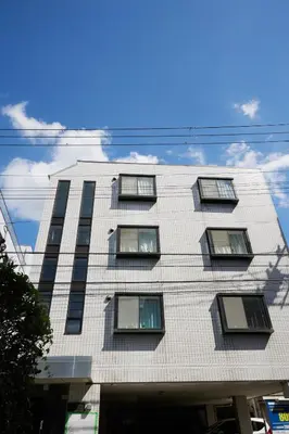 a tall white building with windows on it at K&H立石5丁目m305 in Tokyo