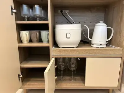 a cabinet with cups and utensils in it at Hotel Shunkashuto Sakura 1 min to station in Tokyo