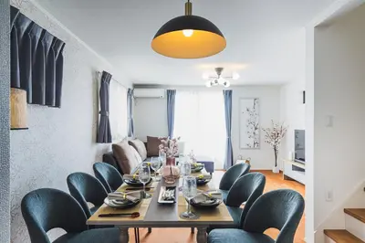 a dining room with a long table and chairs at Hotel Shunkashuto Sakura 1 min to station in Tokyo