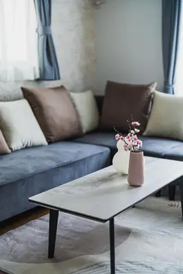 a living room with a couch and a coffee table at Hotel Shunkashuto Sakura 1 min to station in Tokyo