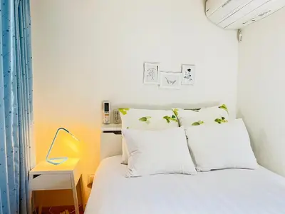 a bedroom with a bed with white sheets and pillows at Ikebukuro\u99c5\u304b\u3089\u5f92\u6b698\u5206\u6700\u59278\u4eba\u6728\u6728\u65e7\u9928 in Tokyo