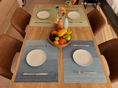 a table with plates and a bowl of fruit on it at nestay apartment tokyo skytree in Tokyo