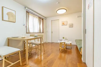 a living room with a table and chairs and a bed at Asakusa Cozy Japanese House with Tatami & Projector, 5min to Station in Tokyo