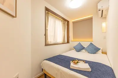 a bedroom with a bed and a window at Asakusa Cozy Japanese House with Tatami & Projector, 5min to Station in Tokyo