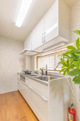 a kitchen with white cabinets and a sink at Asakusa Cozy Japanese House with Tatami & Projector, 5min to Station in Tokyo