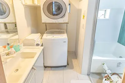 a washer and dryer in a bathroom with a sink at 7 min walk from JR Yamanote Line Uguisudani Spacious 4-Bedroom House near Ueno & Asakusa With Parking in Tokyo
