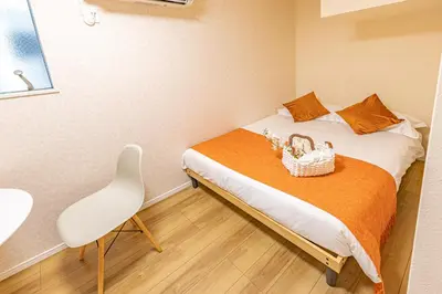 a small bedroom with a bed with a basket on it at 7 min walk from JR Yamanote Line Uguisudani Spacious 4-Bedroom House near Ueno & Asakusa With Parking in Tokyo
