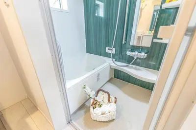 a small bathroom with a shower and a bath tub at 7 min walk from JR Yamanote Line Uguisudani Spacious 4-Bedroom House near Ueno & Asakusa With Parking in Tokyo