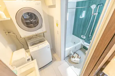 a bathroom with a washing machine and a shower at 7 min walk from JR Yamanote Line Uguisudani Spacious 4-Bedroom House near Ueno & Asakusa With Parking in Tokyo