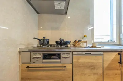 a kitchen with a stove and a counter top at 7 min walk from JR Yamanote Line Uguisudani Spacious 4-Bedroom House near Ueno & Asakusa With Parking in Tokyo