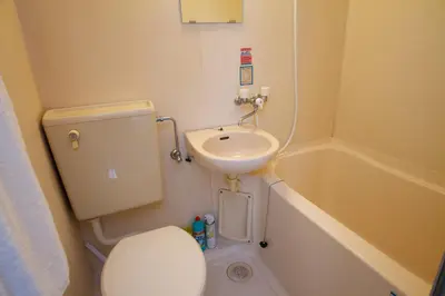 a small bathroom with a toilet and a sink at SunRise STAY Minamidai\u4e2d\u91ce\u5357\u53f0 in Tokyo