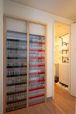 a room with a wall full of knick knacks at SunRise STAY Minamidai\u4e2d\u91ce\u5357\u53f0 in Tokyo