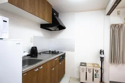 a small kitchen with a sink and a stove at SunRise STAY Minamidai\u4e2d\u91ce\u5357\u53f0 in Tokyo